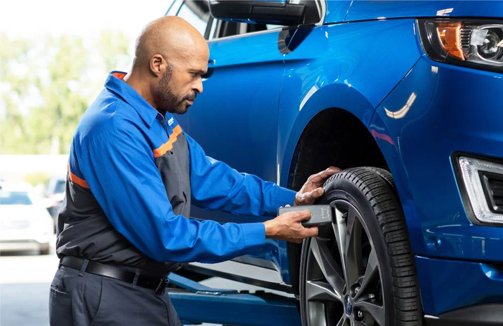 Repairman doing tire service on a car