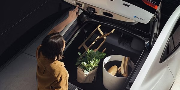 woman closing the trunk of their hybrid Toyota Prius
