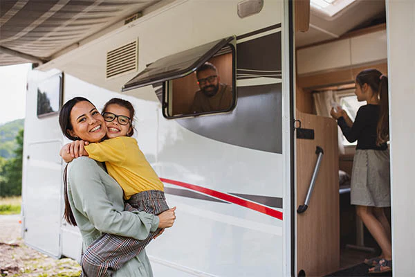 A white modern RV home on wheels parked outdoors