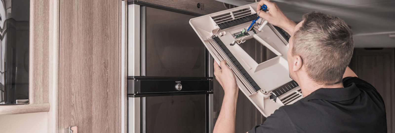 A repairman fixing an RV