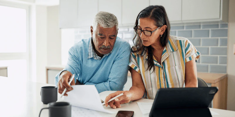 two people looking at laptop for car financing