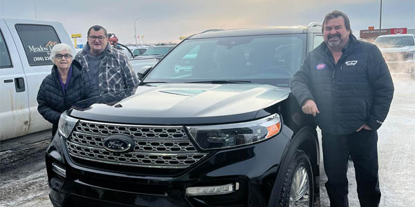 a couple with their just-bought pre-owned vehicle at pineridge ford