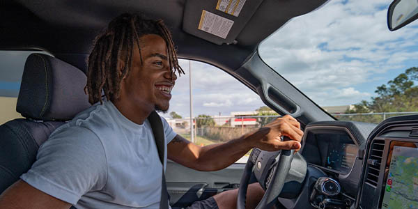 a man driving a ford vehicle