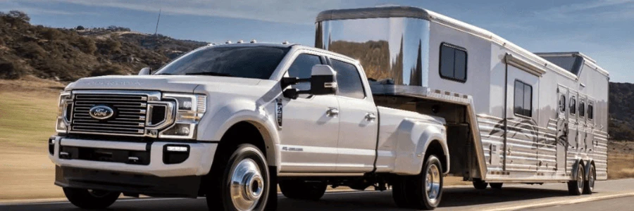 A truck hauling an RV on the road