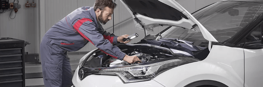 Featured Image service technician under the hood of a Toyota hyrbid