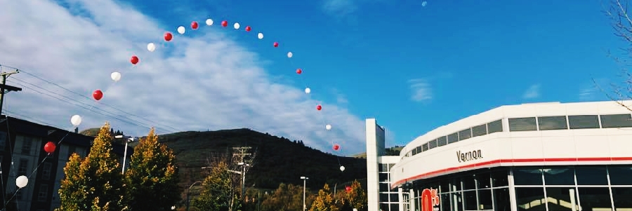 Vernon Toyota's Exterior with red and white balloons over a blue sky