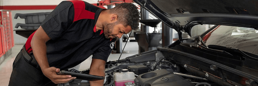 toyota service technician working under the hood