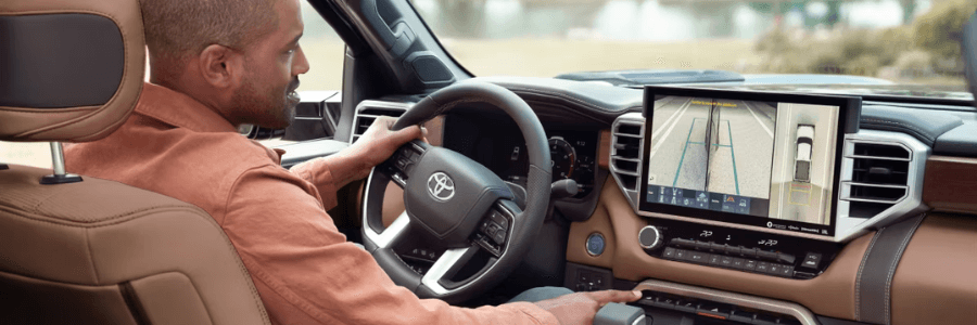 Featured Image man driving a toyota vehicle with tech display screen