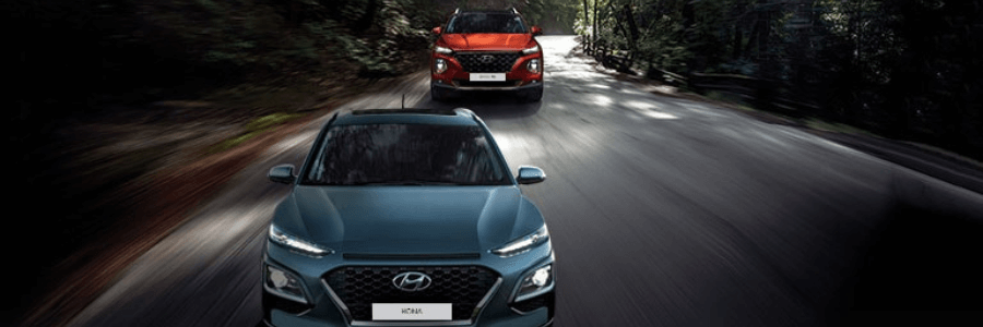 two-hyundai-suvs-driving-on-freeway