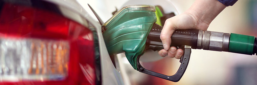 green gas pump with person fuelling up car