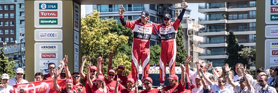 Two Toyota Drivers stand on the car after winning a race