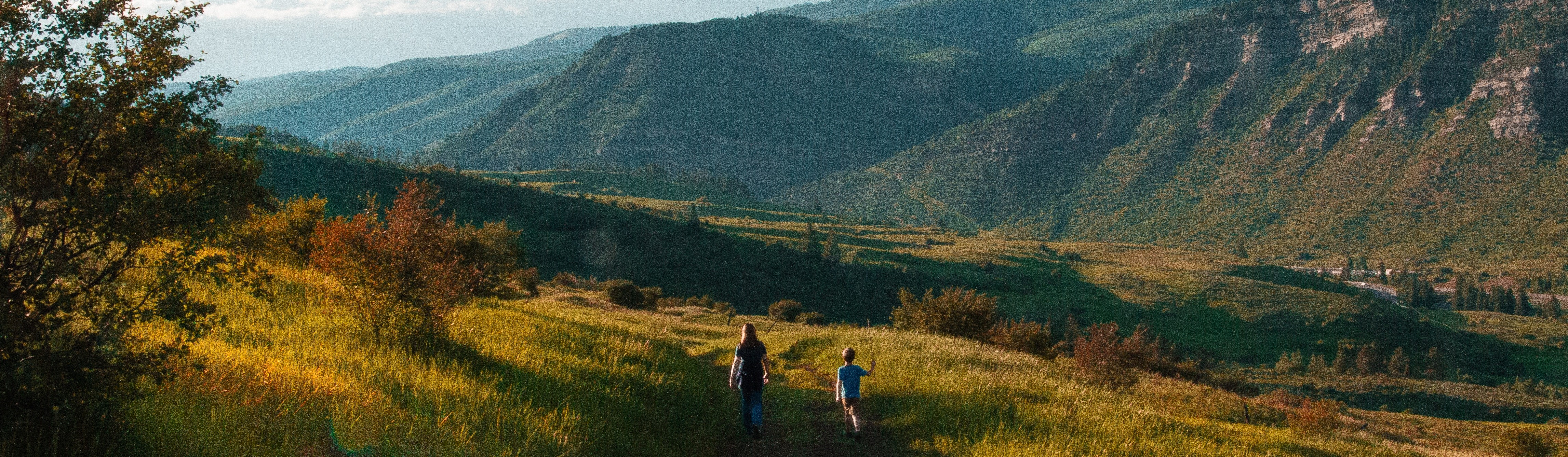 A family hikes through a valley near Castlegar, BC