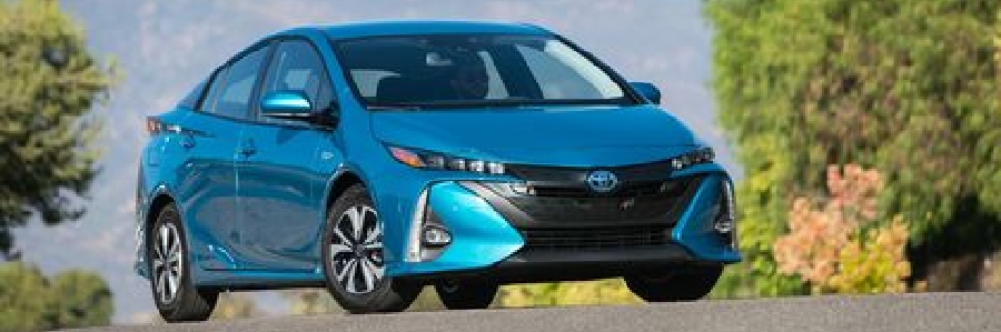A blue Prius Prime drives the streets of Castlegar, BC