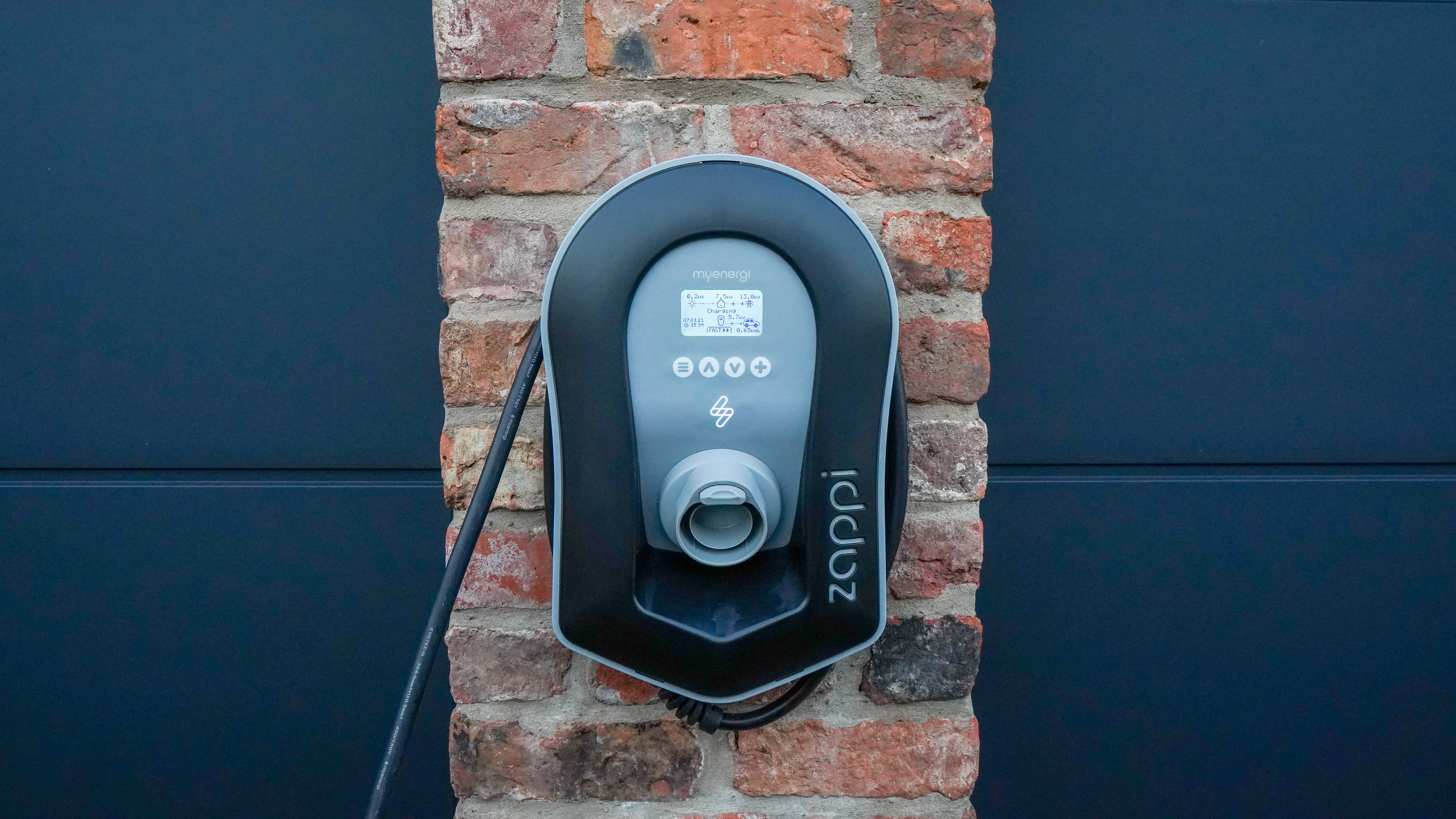 Electric car charger on a brick wall