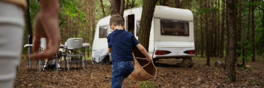 child running with a basket while rving at a campsite