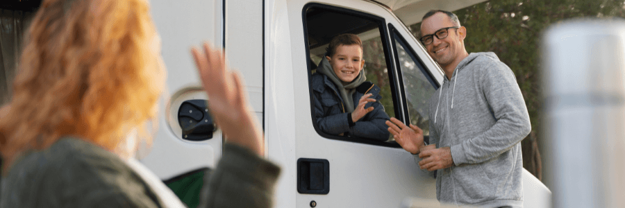 Featured Image woman waving to a man and boy in an RV
