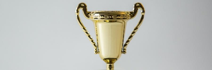 gold trophy on a grey background
