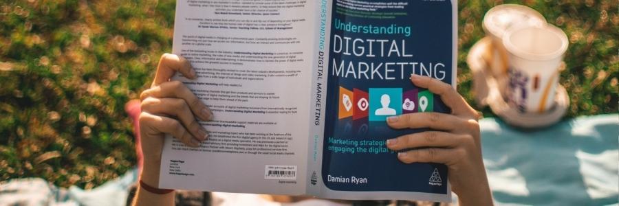 Person reading a book about digital marketing
