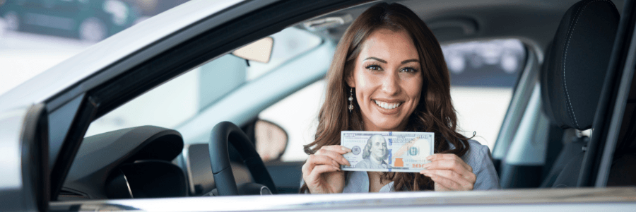 Featured Image woman in a car smiling with cash