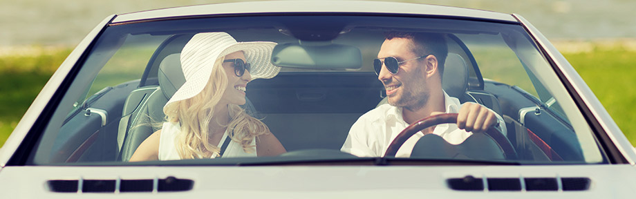 Couple smiling in their luxury car