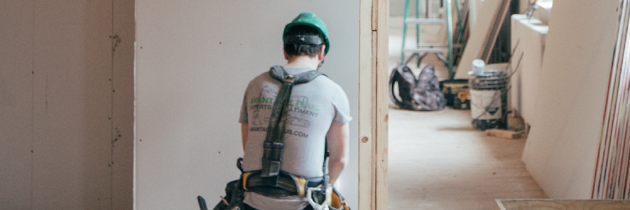 A tradesman works on the interior of a North York building
