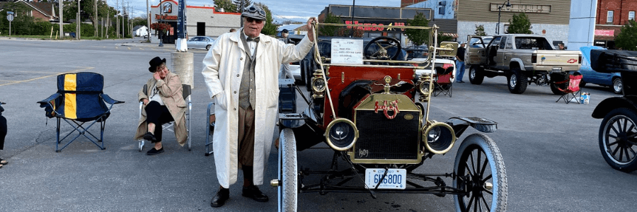 Man stands with vintage Ford vehicle