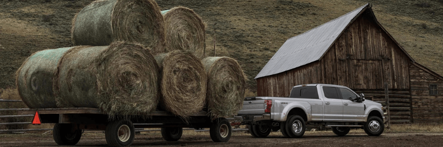 Ford truck towing hay bales