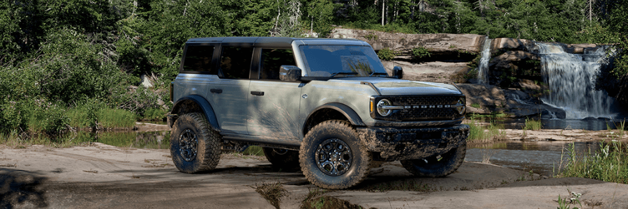 Featured Image Ford Bronco in green at a waterfall trail