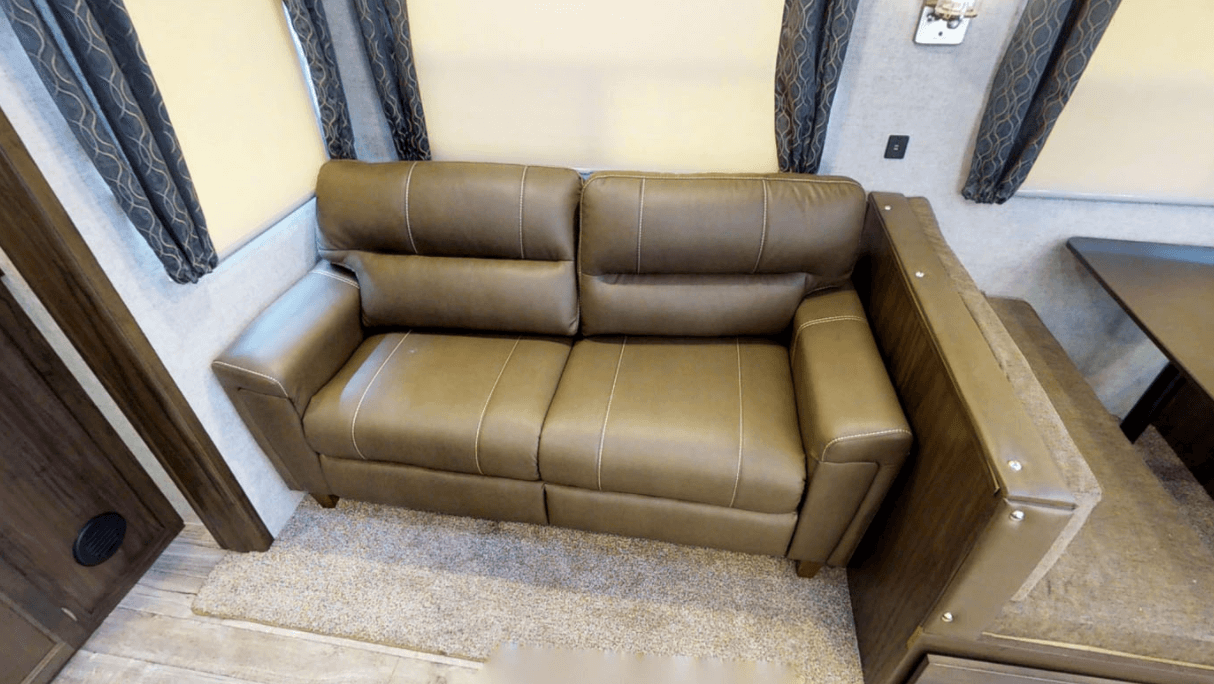 Comfy tan faux leather sofa in Arctic Wolf RV Unit