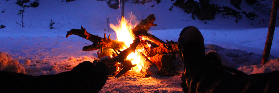 couple roasting food at campfire