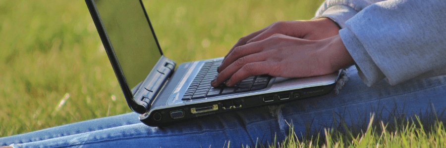 Sitting on grass with laptop