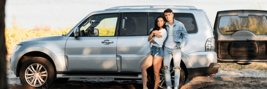 Featured Image couple in front of an SUV