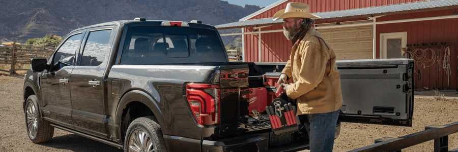 driver opening pickup truck bed