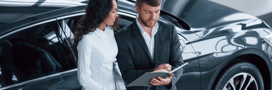 woman and salesman at a car dealership