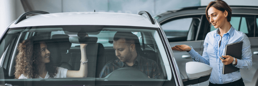 Featured Image couple at a car dealership with saleswoman