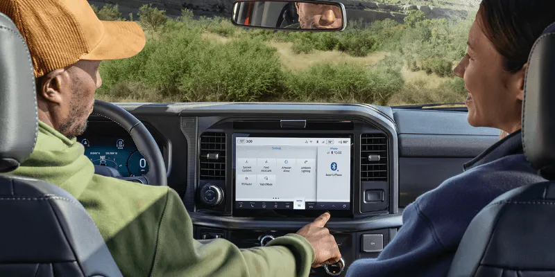 Couple inside a Ford truck using the SYNC touchscreen infotainment system