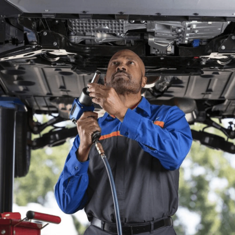 A mechanic fixing a car