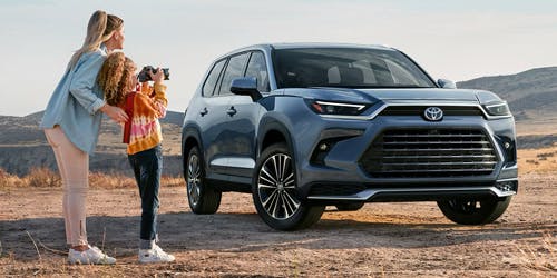 approved financing, mother and daughter beside grand highlander suv