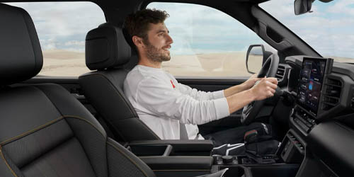 a man driving a toyota vehicle