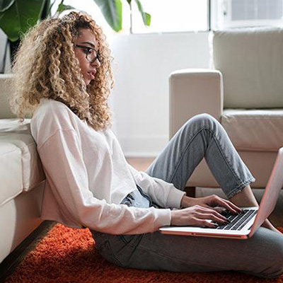 Woman sitting down using laptop