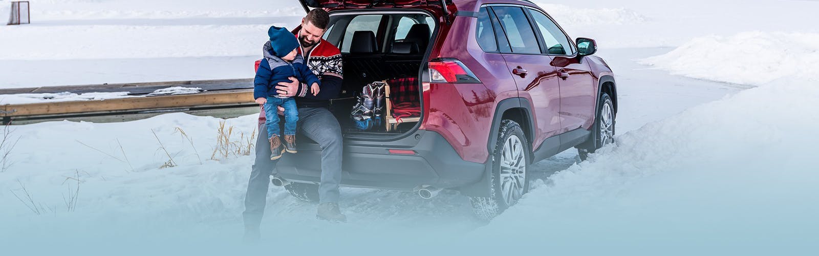 man and son sitting in back of rav4