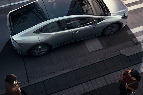 top view exterior view of toyota prius with passer by admiring the aesthetics 