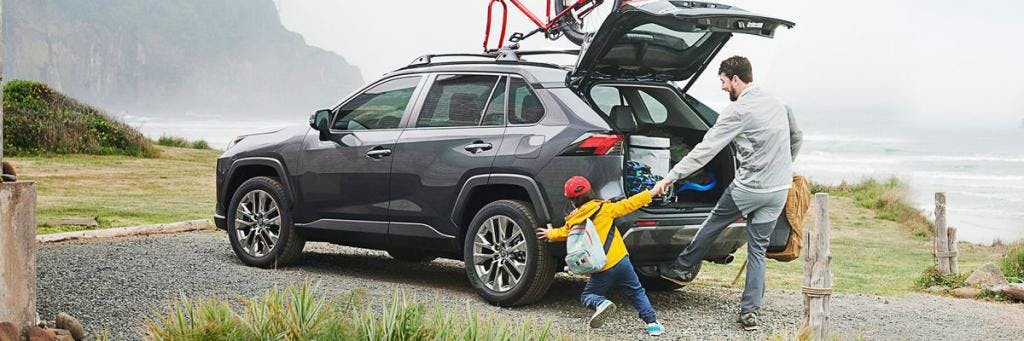 man and sun next to their toyota vehicle