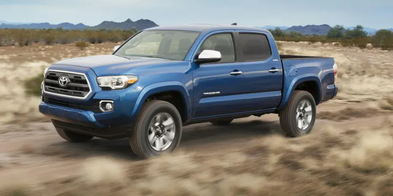 Blue Toyota truck for trail drivers driving through desert landscape