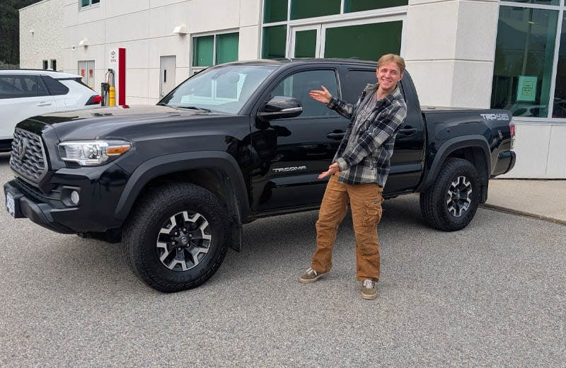 a toyota castlegar customer in front of his new truck