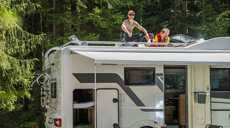 happy-family-relaxing-on-the-roof-of-their-rv
