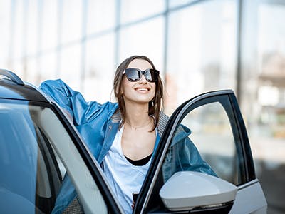 a woman getting out of her car