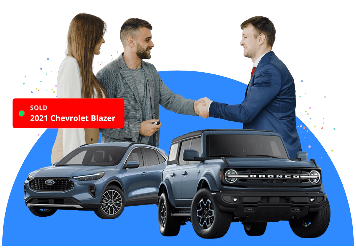 A car sales person shaking hands with a couple