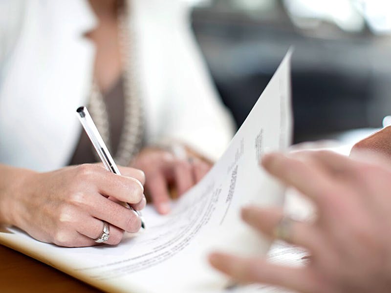 two individuals working through finance papers