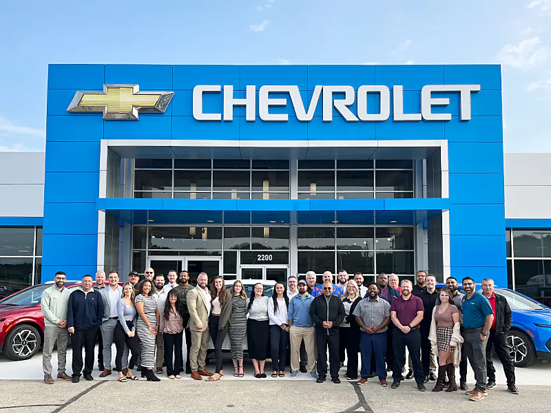 art Moehn Chevrolet team standing outside dealership front
